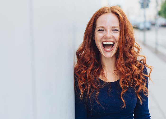 Frau mit roten Haaren, die lächelt