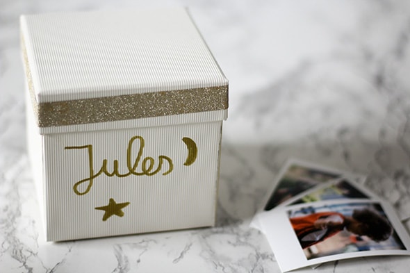 La boite est refermée et a une face décorée d'une étoile, une lune, et le nom Jules