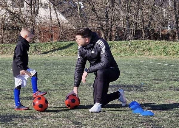 A father playing football with his son